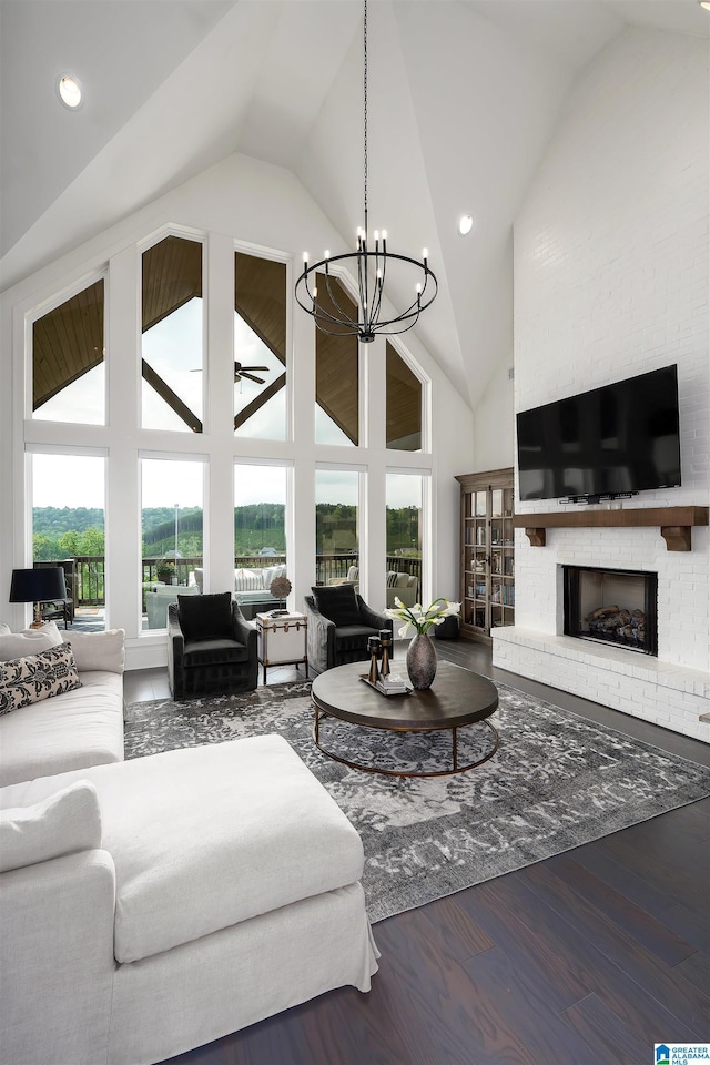1904 Blackridge Rd, Hoover, AL 35244 - living room featuring a brick fireplace, high vaulted ceiling, a chandelier, recessed lighting, and wood finished floors