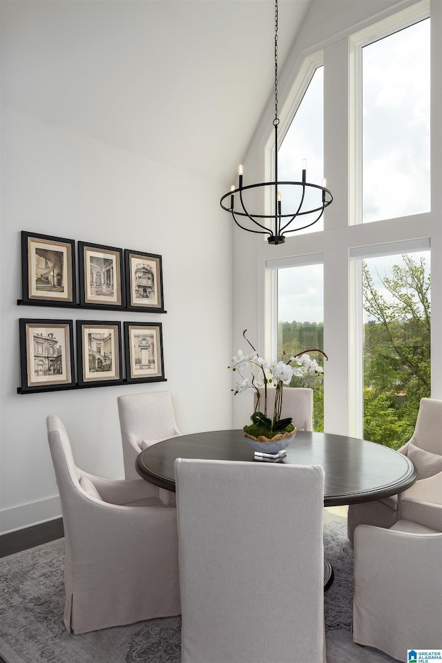 1904 Blackridge Rd, Hoover, AL 35244 - dining area featuring a towering ceiling, baseboards, wood finished floors, and a chandelier