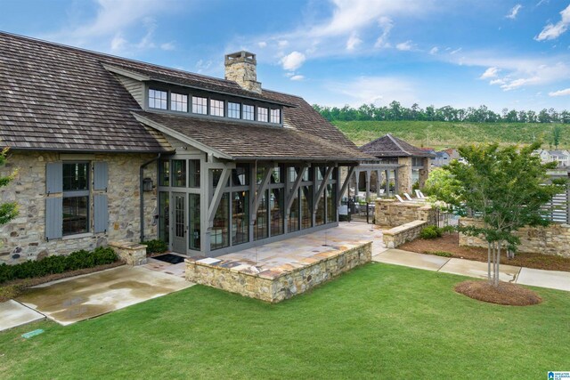 1904 Blackridge Rd, Hoover, AL 35244 - rear view of property featuring a patio, a chimney, a yard, and stone siding