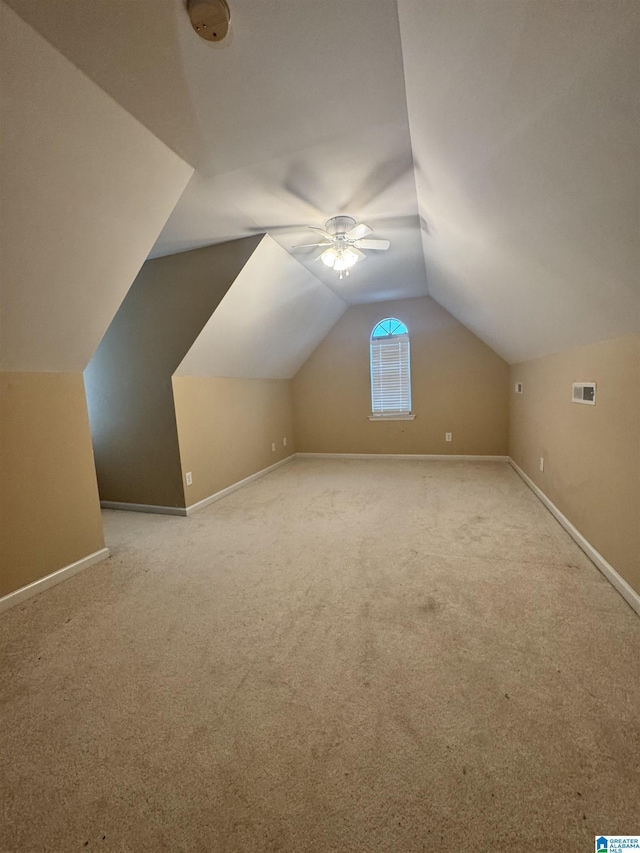 bonus room with vaulted ceiling, visible vents, baseboards, and ceiling fan