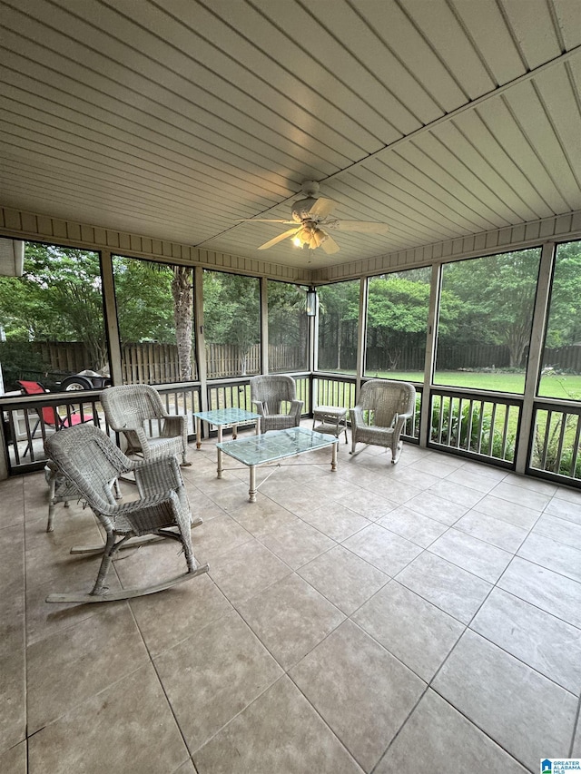 sunroom / solarium with ceiling fan and an outdoor living space