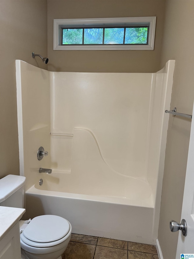 bathroom featuring toilet, vanity, and washtub / shower combination