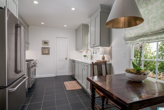 kitchen with high quality appliances, light countertops, dark tile patterned floors, and gray cabinets