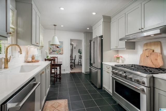kitchen with tasteful backsplash, a sink, appliances with stainless steel finishes, light countertops, and under cabinet range hood