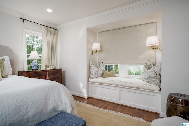 bedroom with wood finished floors, recessed lighting, and ornamental molding