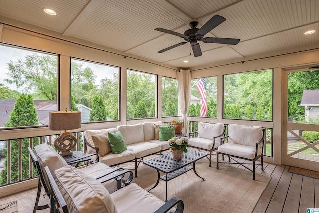 sunroom / solarium featuring an outdoor living space, a ceiling fan, and a wealth of natural light