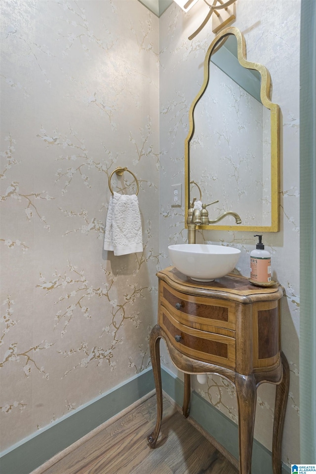bathroom featuring vanity, baseboards, and wood finished floors