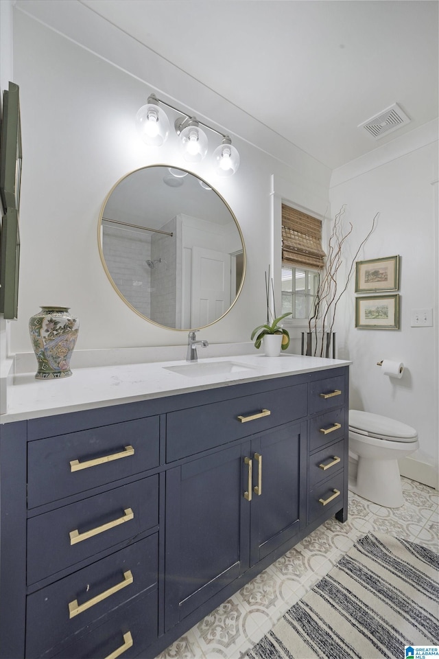 bathroom with visible vents, tile patterned flooring, toilet, and vanity