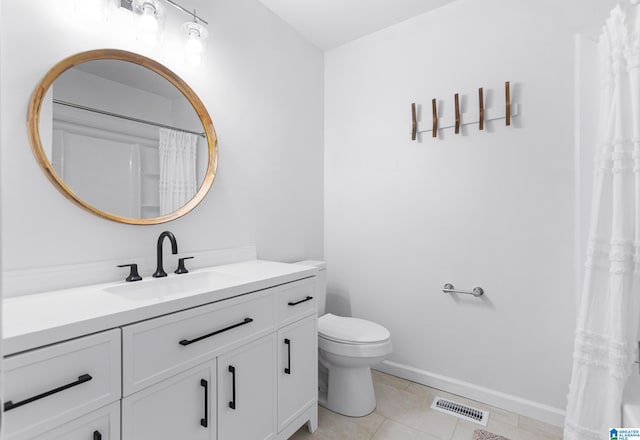 bathroom with vanity, tile patterned floors, toilet, visible vents, and baseboards