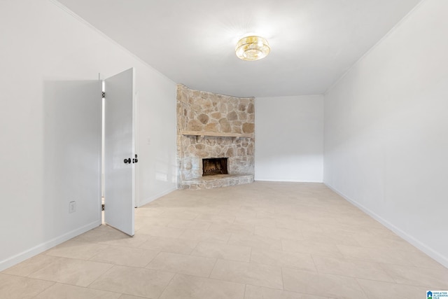 unfurnished living room featuring baseboards and a fireplace
