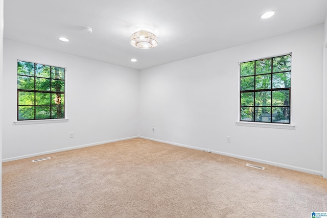 carpeted spare room with recessed lighting, visible vents, and baseboards