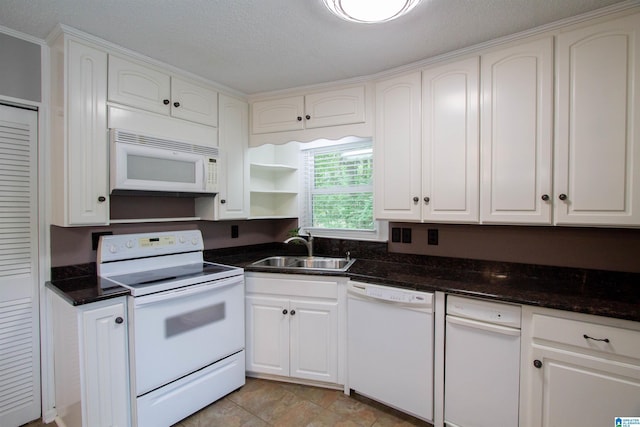 kitchen with open shelves, a sink, white cabinets, dark stone countertops, and white appliances