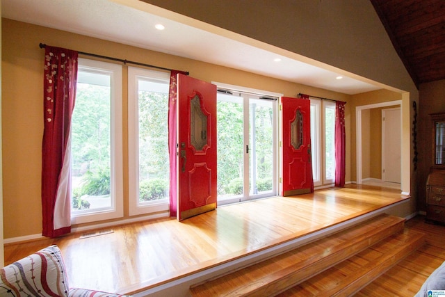 foyer entrance with visible vents, recessed lighting, baseboards, and wood finished floors