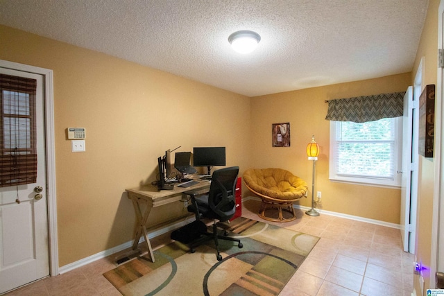 office area with baseboards, a textured ceiling, and tile patterned flooring