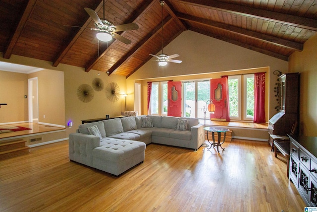 living area with beamed ceiling, ceiling fan, wood ceiling, and wood finished floors