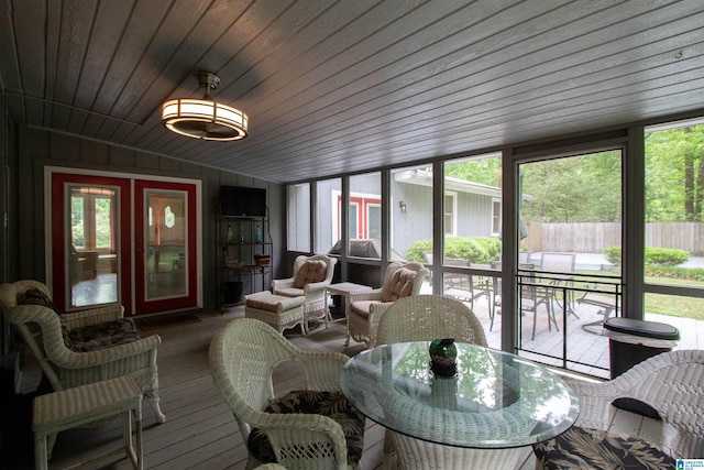 sunroom featuring outdoor dining area