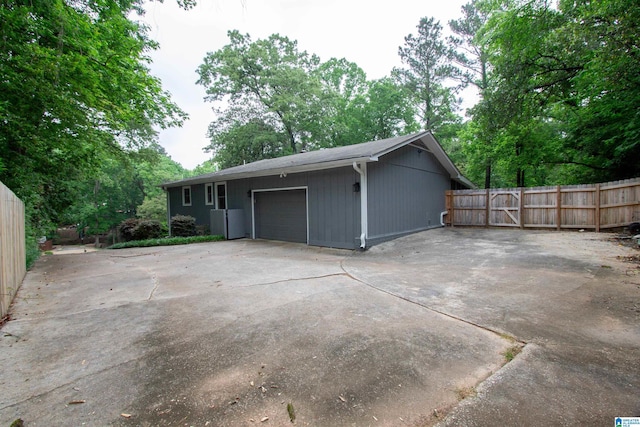 garage featuring fence and driveway