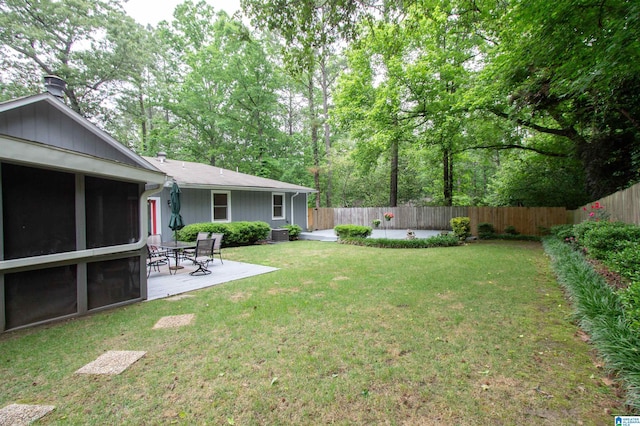 view of yard with central air condition unit, a patio, a fenced backyard, and a sunroom