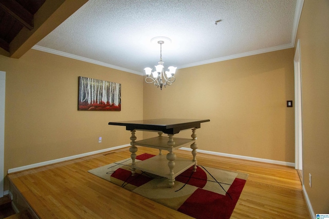 dining area with baseboards, an inviting chandelier, ornamental molding, and light wood-style floors