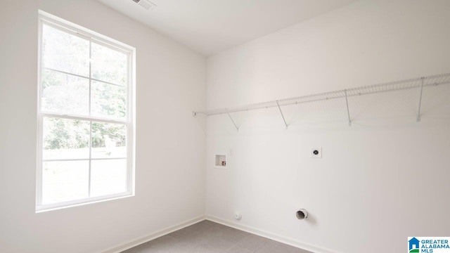 laundry room with washer hookup, baseboards, electric dryer hookup, and laundry area