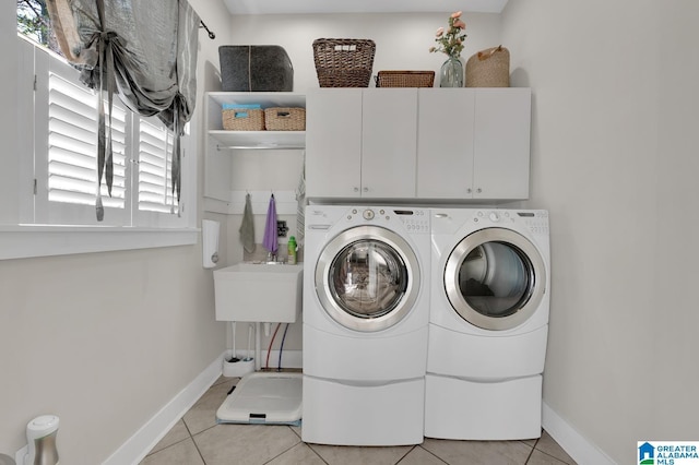 190 Drennen Park Cir, Hayden, AL 35079 - laundry room featuring independent washer and dryer, cabinet space, light tile patterned floors, and baseboards