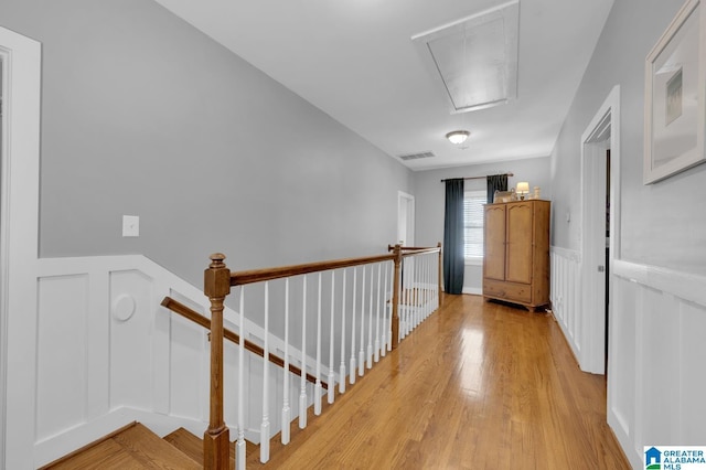 190 Drennen Park Cir, Hayden, AL 35079 - hall featuring attic access, an upstairs landing, a decorative wall, light wood-style floors, and a wainscoted wall