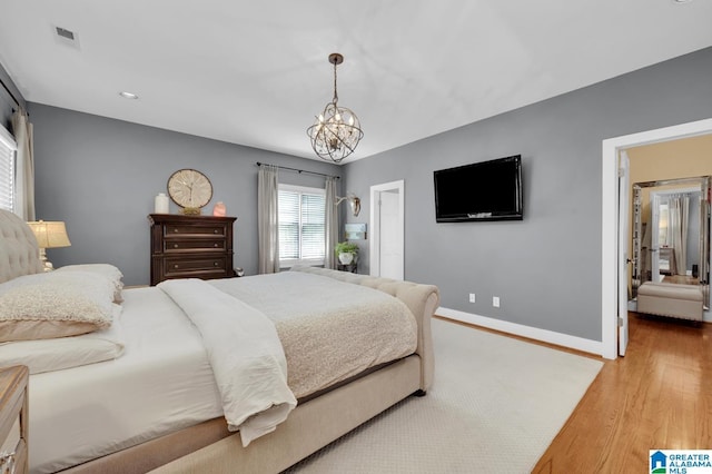 190 Drennen Park Cir, Hayden, AL 35079 - bedroom with wood finished floors, a chandelier, and baseboards