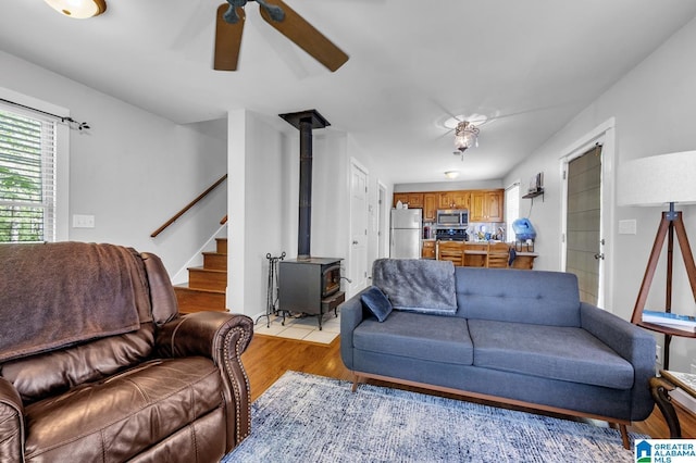 190 Drennen Park Cir, Hayden, AL 35079 - living area featuring a wood stove, ceiling fan, light wood finished floors, and stairs