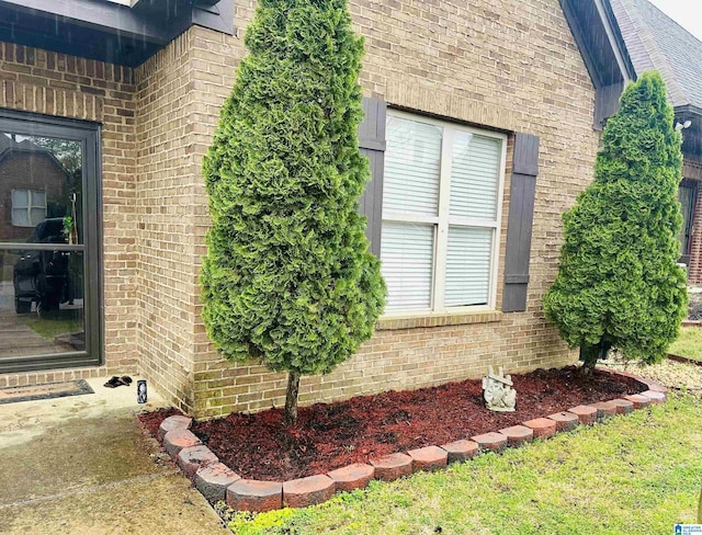 view of side of home featuring brick siding
