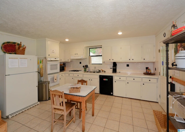 kitchen with white cabinetry, light tile patterned flooring, white appliances, and light countertops