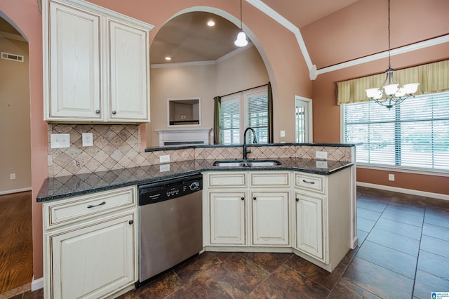 kitchen featuring crown molding, a peninsula, arched walkways, a sink, and dishwasher