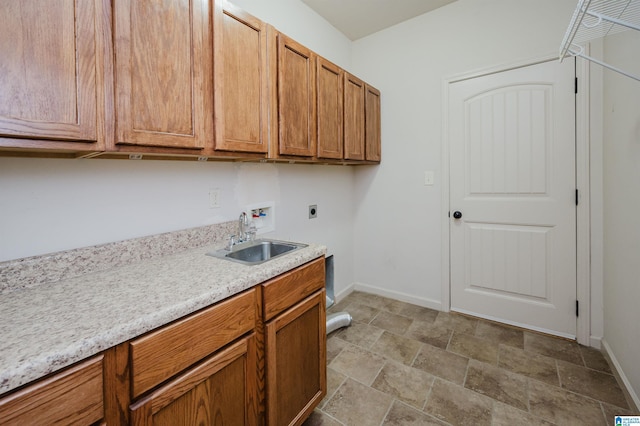 laundry area featuring cabinet space, washer hookup, a sink, baseboards, and hookup for an electric dryer