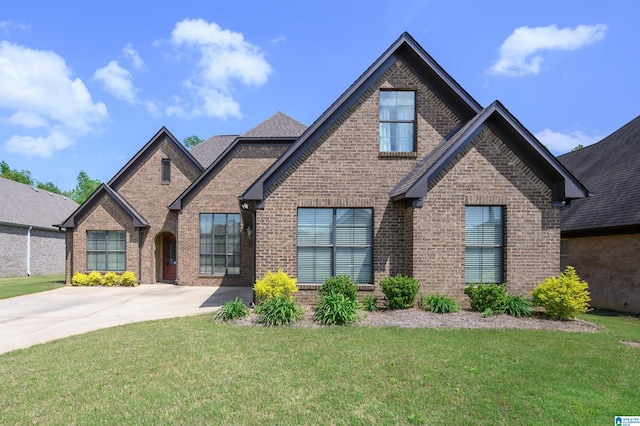 craftsman-style home featuring brick siding and a front lawn