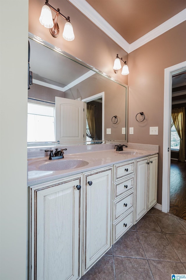 bathroom featuring crown molding, a sink, tile patterned floors, and double vanity