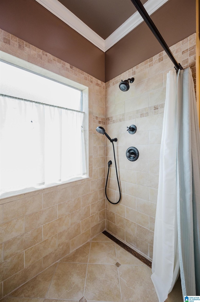 bathroom with crown molding and a tile shower