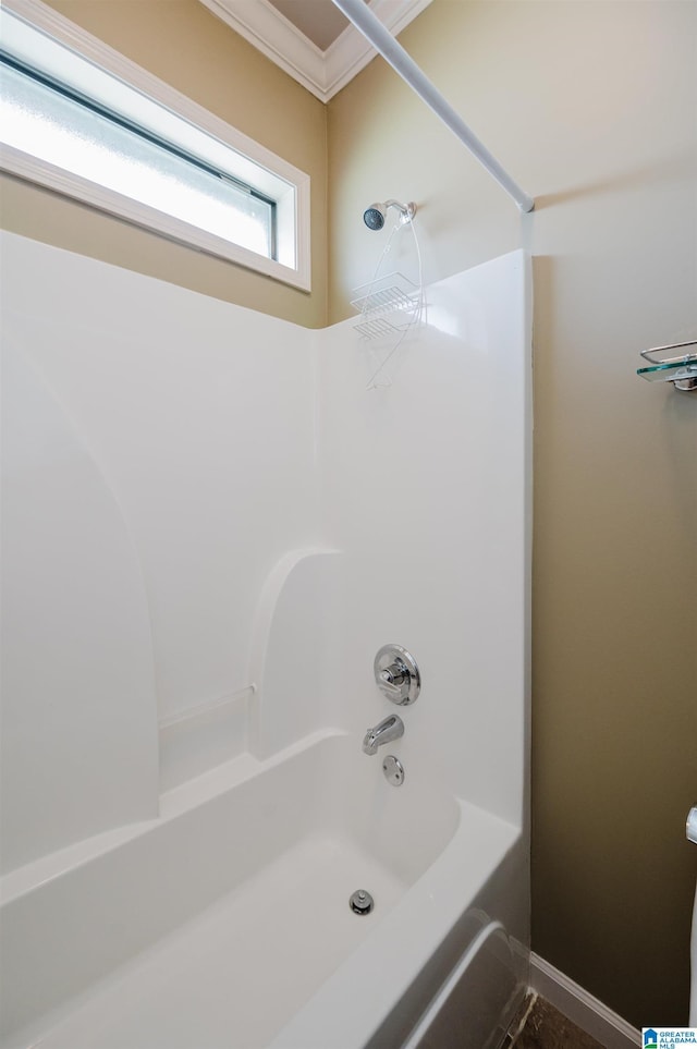 full bath with crown molding, washtub / shower combination, and baseboards