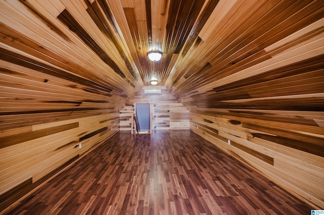 additional living space with wood walls, dark wood-style floors, and wood ceiling