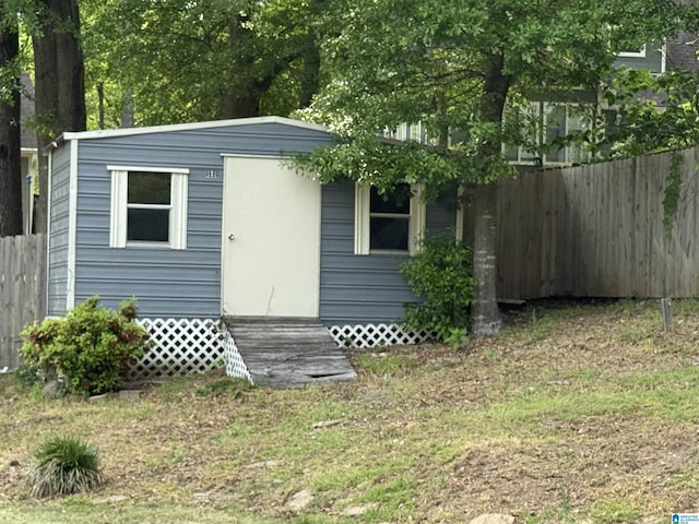 view of shed featuring fence