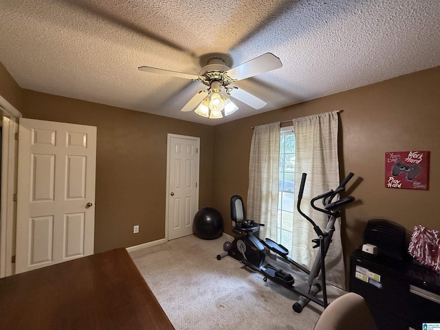 exercise area with carpet flooring, a textured ceiling, and ceiling fan