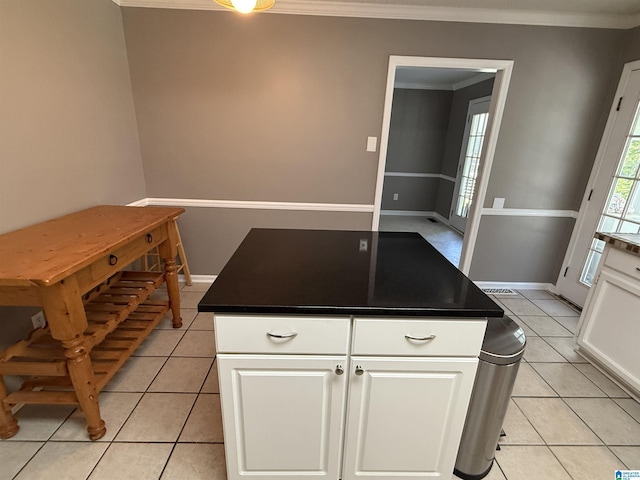 96 Tomahawk Cir, Pelham, AL 35124 - kitchen featuring crown molding, white cabinetry, light tile patterned floors, and dark countertops