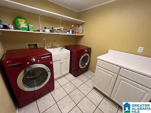 96 Tomahawk Cir, Pelham, AL 35124 - laundry room featuring cabinet space, light tile patterned floors, ornamental molding, and separate washer and dryer