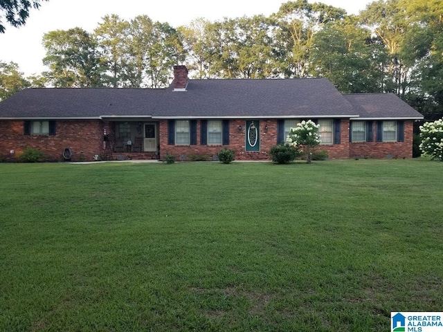 1003 Old Samaria Rd, Clanton, AL 35045 - ranch-style home with a chimney, brick siding, a shingled roof, and a front yard