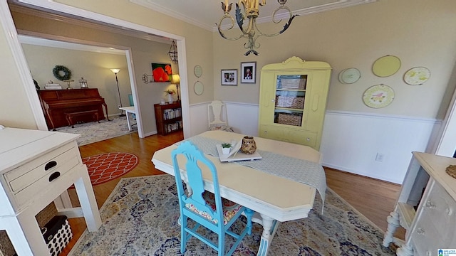 214 Scotts Trce, Helena, AL 35022 - dining space with crown molding, a wainscoted wall, wood finished floors, and a chandelier