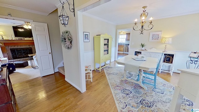 214 Scotts Trce, Helena, AL 35022 - dining room featuring crown molding, light wood-style flooring, and a brick fireplace