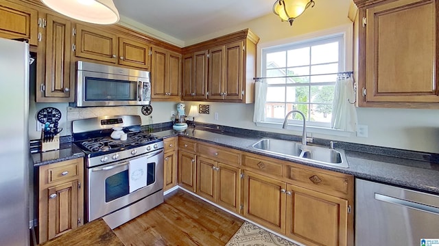 214 Scotts Trce, Helena, AL 35022 - kitchen with dark wood-style flooring, appliances with stainless steel finishes, dark countertops, brown cabinets, and a sink