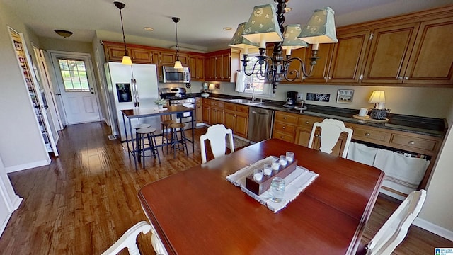 214 Scotts Trce, Helena, AL 35022 - kitchen featuring dark countertops, an inviting chandelier, stainless steel appliances, baseboards, and dark wood-type flooring