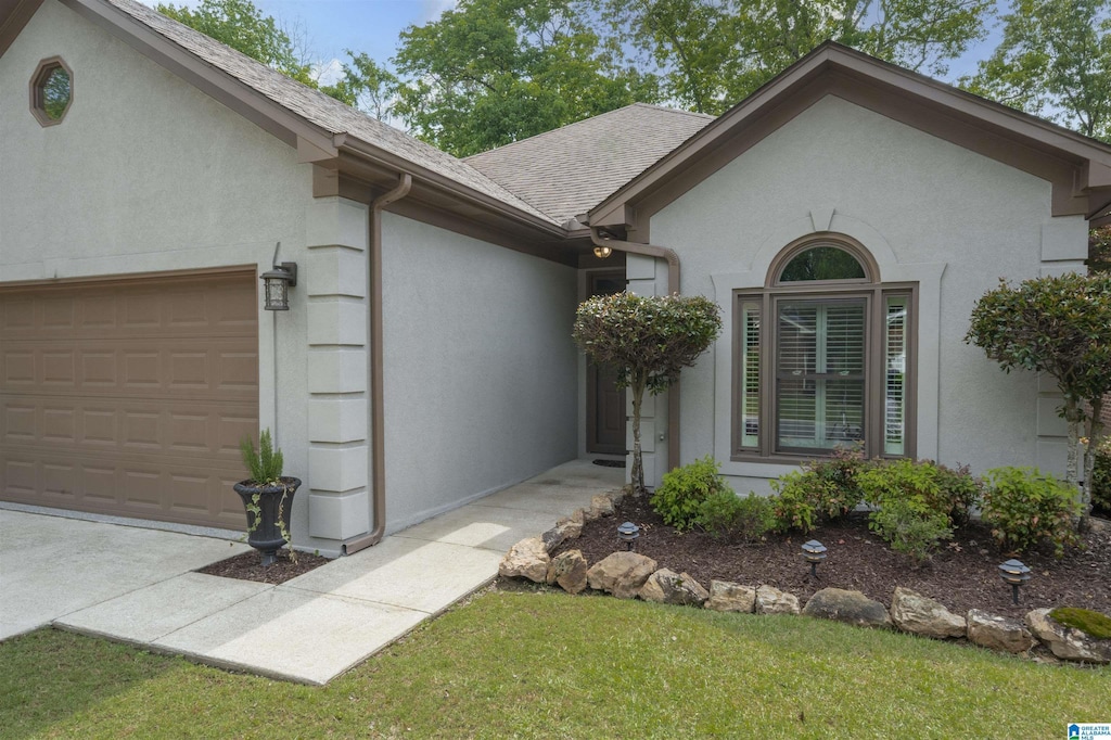1148 Berwick Rd, Hoover, AL 35242 - view of front of property with a shingled roof, stucco siding, a front yard, and an attached garage