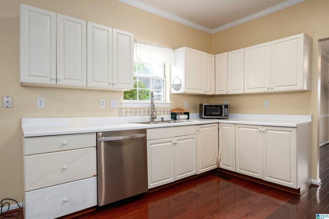 kitchen with appliances with stainless steel finishes, white cabinets, dark wood finished floors, and a sink