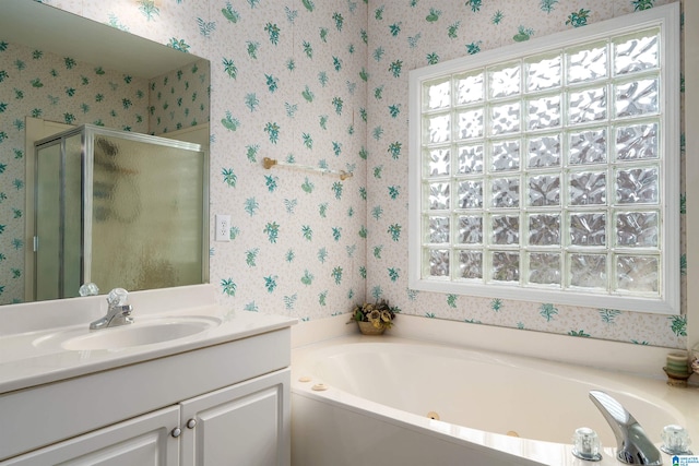 full bathroom with wallpapered walls, a stall shower, a garden tub, and plenty of natural light