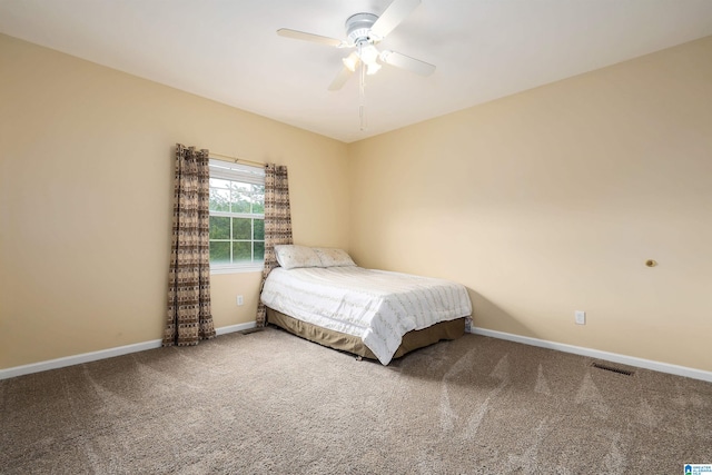 bedroom with carpet flooring, visible vents, ceiling fan, and baseboards